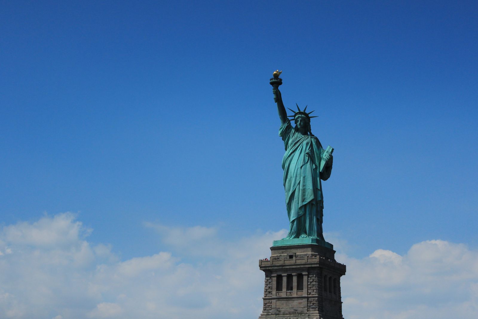 Statue of Liberty standing against a clear blue sky in New York
