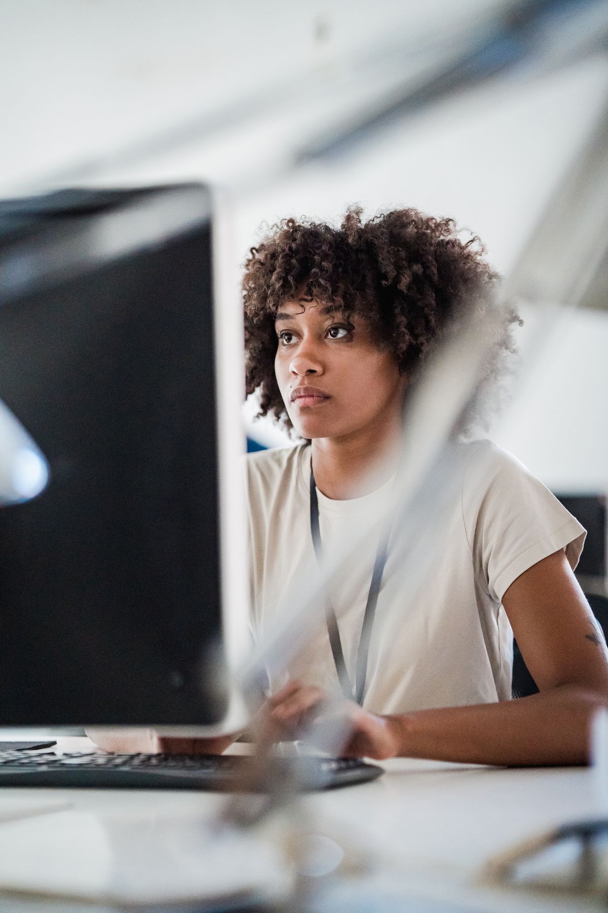 Office worker concentrating on a computer screen at a modern desk